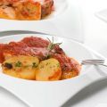 Chuletas de cerdo con tomate al horno